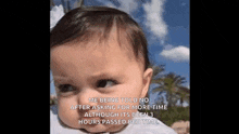 a close up of a baby 's face with a caption .