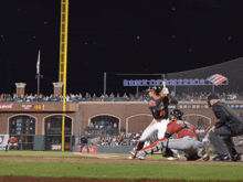 a baseball game is being played in front of a sign that says bank of america