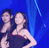 a woman in a red dress is dancing on a stage in front of a blue light .