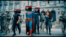 a group of soldiers are walking down a street with a superman and a black widow in front of them