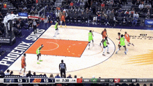 a basketball game is being played in front of a phoenix suns banner