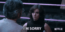 a woman says i 'm sorry in front of a man in a boxing ring