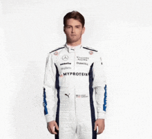 a man in a williams racing uniform is juggling tomatoes