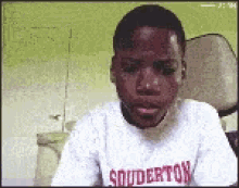 a boy wearing a shirt that says souderton