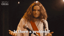 a woman stands in front of a microphone with the words is there a problem written on the bottom
