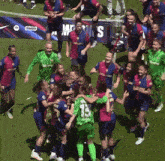 a group of female soccer players celebrate with a banner that says ' bimbo ' on it