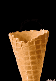a waffle cone with a face in it and the words gifsdayrol below it