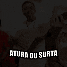 a man is holding a guitar with the word atura on it