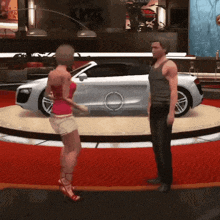 a man and a woman standing in front of a silver car