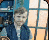 a blurry picture of a man in a blue vest