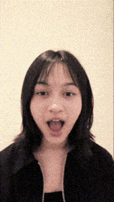 a young woman with her mouth open and her tongue out