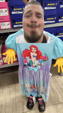 a man is wearing a dress with a mermaid on it