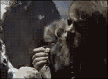 a pixelated image of a man smoking a cigarette with the website 4gifs.com in the lower right corner