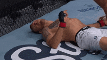 a man laying on a mat that says ufc