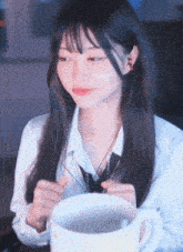 a girl in a white shirt and tie is holding a cup