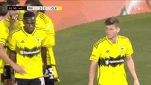 a group of soccer players wearing yellow jerseys that say nationalwide on them