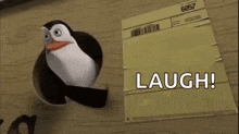 a penguin is sticking its head out of a hole in a piece of paper and laughing .