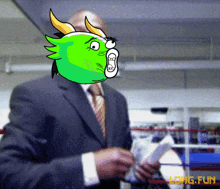 a man in a suit and tie is holding a piece of paper in front of a boxing ring that says long fun on it