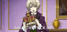 a man in a purple suit is holding a crown and the words shut the fuck up are below him