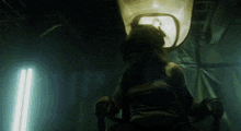 a woman in a mask is sitting in a chair
