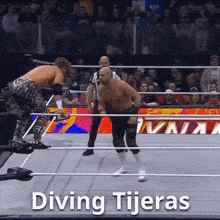 two wrestlers in a wrestling ring with the words diving tijeras written on the bottom