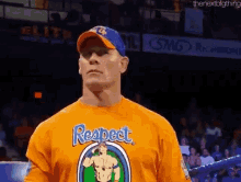 a man wearing a shirt that says respect is standing in a ring .