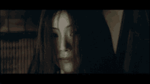 a close up of a woman 's face with a scary look on her face