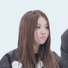 a girl with braided hair has a sticker on her jacket that says ' evelyn '
