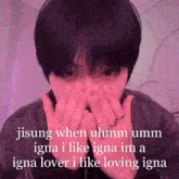 a man covering his face with his hands with a caption that says jisung