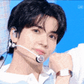 a close up of a person wearing a microphone and a watch with the word live in the corner