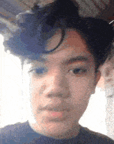 a close up of a young man 's face with a slight smile on his face
