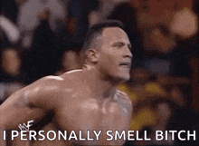 a shirtless wrestler is saying `` i personally smell bitch '' while standing in front of a crowd .