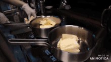 two pans of butter are being cooked on a stove with the words made in animotica visible
