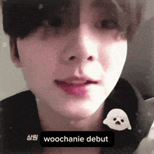 a close up of a person 's face with a sticker that says woochanie debut