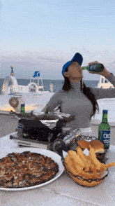 a woman is drinking from a bottle that says coca cola on it