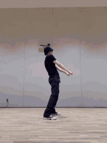 a man is dancing on a wooden floor in a room .