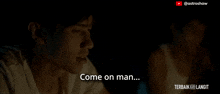 a man in a white shirt is talking to another man in the dark and says come on man