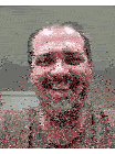 a man with a beard is smiling with his mouth open