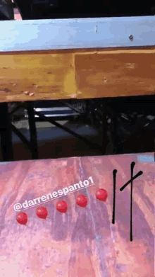 a sign that says darrenespanto1 on it with red balloons on it