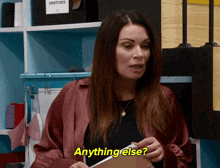 a woman holding a piece of paper with the words anything else above her