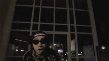 a person wearing sunglasses and a headband that says midnight on it