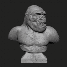 a statue of a gorilla 's head is shown on a dark background
