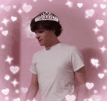a young man wearing a white shirt and a tiara on his head