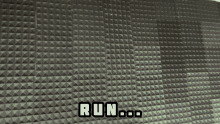 a man standing in front of a wall that says run on it