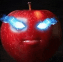 a red apple with blue eyes that looks like a devil .