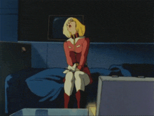 a girl in a red jacket is laying on a blue blanket
