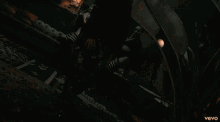 a man and two women are dancing in a video that says vevo on the bottom right