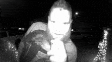 a man with a beard is standing in front of a doorbell camera .