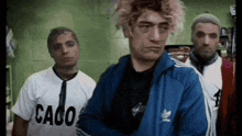 a group of men are standing next to each other in a room .