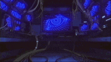 a room with a lot of wires hanging from the ceiling and a window with a blue light coming out of it .